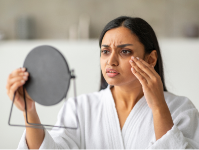 Woman examining thinning hair
